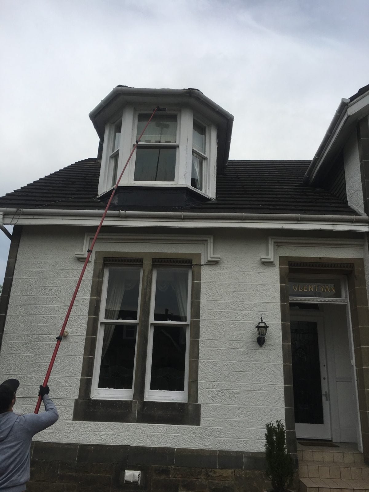 Professional window cleaning Airdrie service performed by ClearSky technician using pure water fed pole system on a residential home