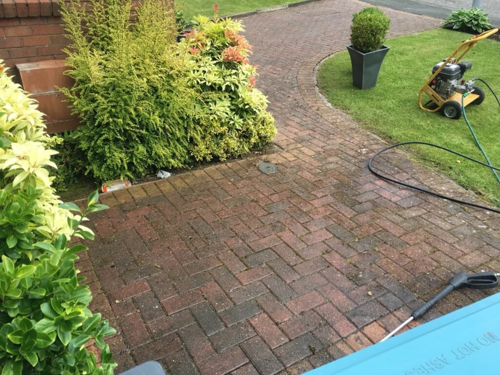 Monoblock driveway in Airdrie being pressure washed, petrol machine and lance on the drive